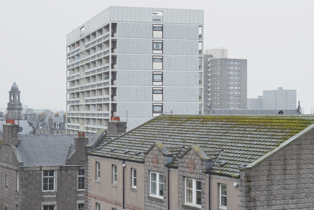 View from the Chapel Street. Gilcomstoun Land, the slab block in the foreground rising above old Victorian granite structures and more recent residential buildings. Denburn Court and Hutcheon Court high rises are visible in the background.